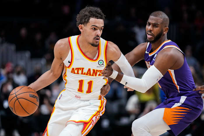 Feb 3, 2022; Atlanta, Georgia, USA; Atlanta Hawks guard Trae Young (11) dribbles against Phoenix Suns guard Chris Paul (3) during the first quarter at State Farm Arena